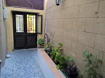 a door of a building with plants next to it at Stathis in Rhodes Town