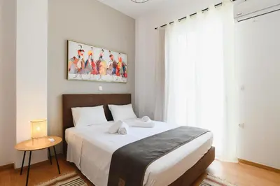 a bedroom with a large white bed in a room at Mandraki City Center Apartments in Rhodes Town