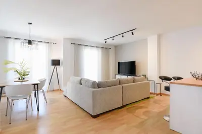a living room with a couch and a table at Mandraki City Center Apartments in Rhodes Town