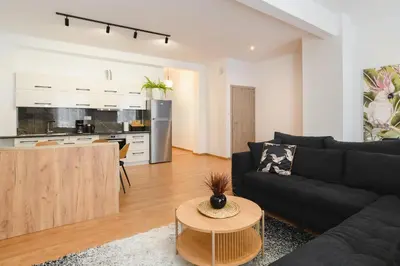 a living room with a couch and a table at Mandraki City Center Apartments in Rhodes Town