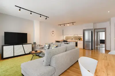 a living room with a couch and a kitchen at Mandraki City Center Apartments in Rhodes Town