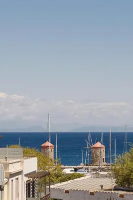 a view of the ocean and some buildings and the water at Mandraki City Center Apartments in Rhodes Town