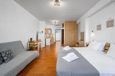 a living room with two beds and a couch at Stegnale Studios in Archangelos