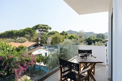 a balcony with a table and a view at Sweet Home Luxury Apartments in Ialyssos