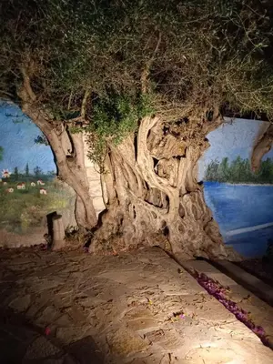 a painting of a large tree in front of a body of water at Sweet Home Luxury Apartments in Ialyssos