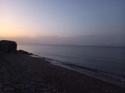 a beach with the ocean in the background at Sweet Home Luxury Apartments in Ialyssos