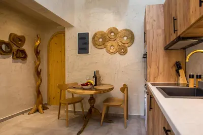 a kitchen with a table and chairs in a room at Saint Zoe Suites in Rhodes Town