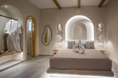 a bedroom with a large bed and a display case at Saint Zoe Suites in Rhodes Town