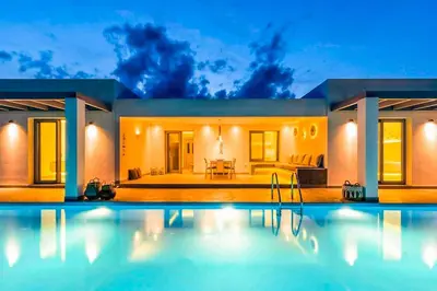 a house with a swimming pool in front of it at Villa Anthos Kerasia in Gennadi