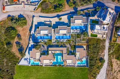 an overhead view of a house with blue roofs at Villa Anthos Kerasia in Gennadi