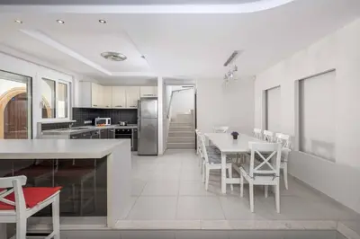 a kitchen and dining room with a table and chairs at Paradise Beach II in Kiotari
