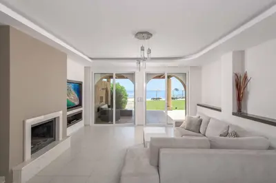 a living room with a couch and a fireplace at Paradise Beach II in Kiotari