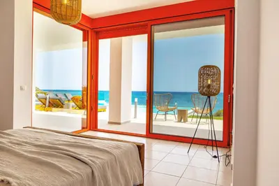 a bedroom with a view of the ocean at Villa Seven in Lachania