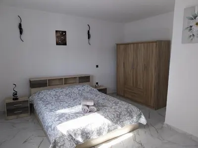a bedroom with a bed with two donuts on it at Paradis Studios in Archangelos