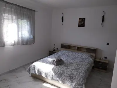 a bedroom with a bed with a stuffed animal on it at Paradis Studios in Archangelos