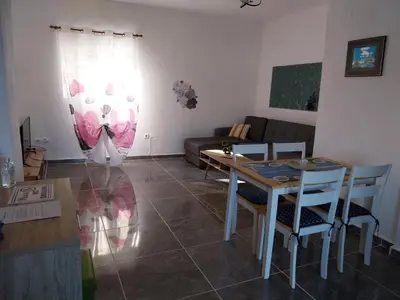 a living room with a table and a couch at Paradis Studios in Archangelos