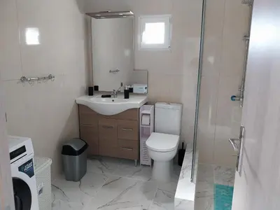 a bathroom with a toilet and a sink and a shower at Paradis Studios in Archangelos