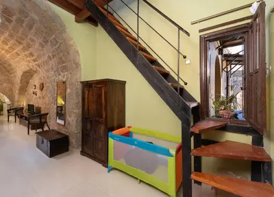 a living room with a staircase and a play area at Studio Astero in Rhodes Town