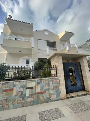 a large white house with a blue door at Studio Irene, Lindos 10 minutes, Beach 4 minutes in vlicha