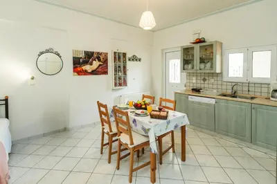 a kitchen and dining room with a table and chairs at Studio Irene, Lindos 10 minutes, Beach 4 minutes in vlicha