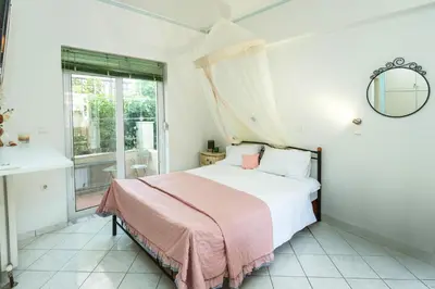 a bedroom with a bed and a window at Studio Irene, Lindos 10 minutes, Beach 4 minutes in vlicha