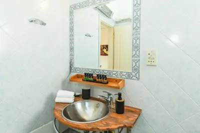 a bathroom with a sink and a mirror at Studio Irene, Lindos 10 minutes, Beach 4 minutes in vlicha