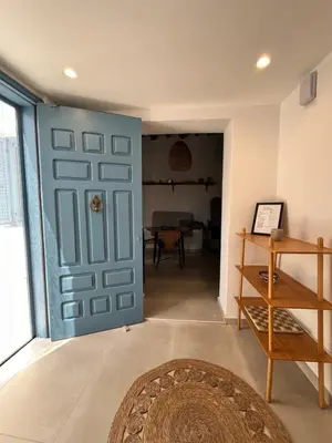 a blue door in a room with a table at Casa Stergia - Village Project in Psinthos