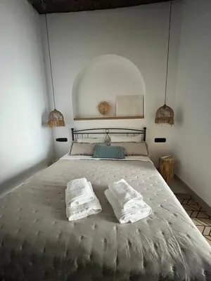 a bedroom with a large bed with two pillows on it at Casa Stergia - Village Project in Psinthos