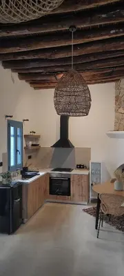 a large kitchen with a stove and a ceiling at Casa Stergia - Village Project in Psinthos