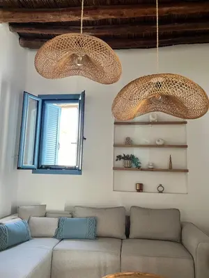 a living room with a couch and two chandeliers at Casa Stergia - Village Project in Psinthos