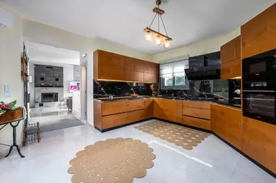 a large kitchen with wooden cabinets and a rug at Hideaway Villa in Triánta