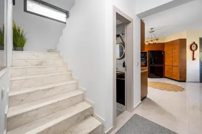 a staircase in a home with white walls at Hideaway Villa in Triánta