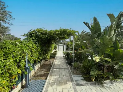a walkway through a garden with plants at Hideaway Villa in Triánta