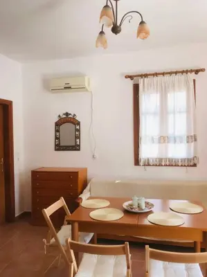 a living room with a table and a couch at Sofia’s Studio in Arnítha