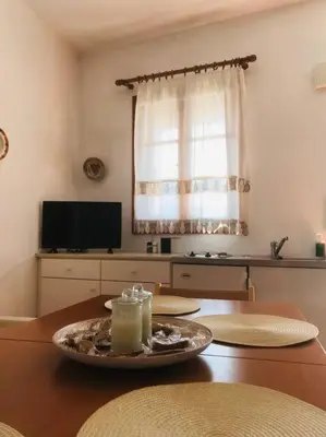 a living room with a table with a candle on it at Sofia’s Studio in Arnítha