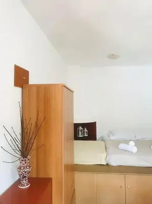 a bedroom with a bed and a vase on a table at Sofia’s Studio in Arnítha