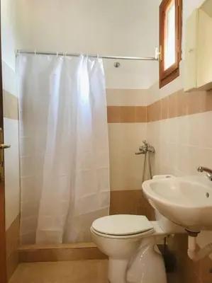 a bathroom with a toilet and a sink at Sofia’s Studio in Arnítha