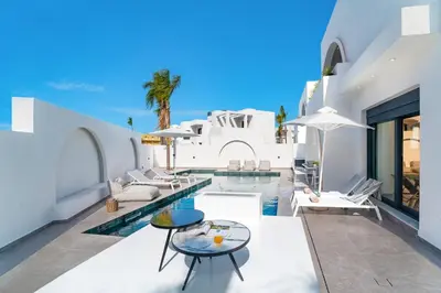 a villa with a swimming pool and a resort at Villa Dolce Vita Evelia by Villa Plus in Ialyssos