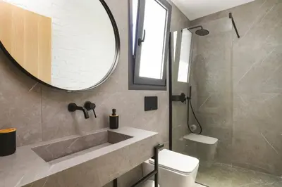 a bathroom with a sink and a mirror and a toilet at Villa Dolce Vita Evelia by Villa Plus in Ialyssos