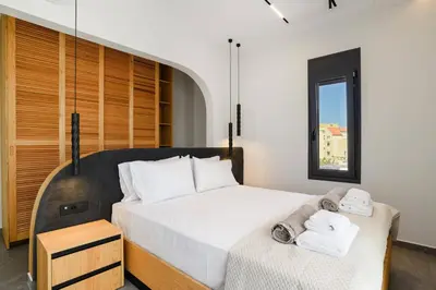 a bedroom with a large bed with towels on it at Villa Dolce Vita Evelia by Villa Plus in Ialyssos