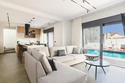 a living room with a couch and a table at Villa Dolce Vita Evelia by Villa Plus in Ialyssos