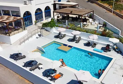 an overhead view of a pool with chairs and umbrellas at Eagles Nest in Pefki Rhodes