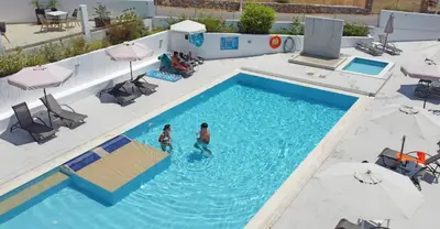 two people are standing in a swimming pool at Eagles Nest in Pefki Rhodes