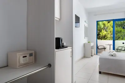 a white room with a kitchen with a microwave at Eagles Nest in Pefki Rhodes
