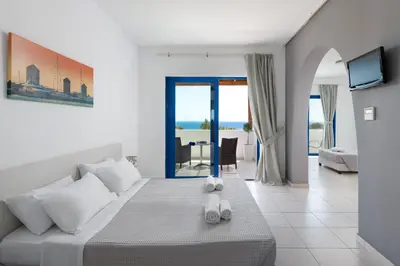a bedroom with a bed and a living room at Eagles Nest in Pefki Rhodes