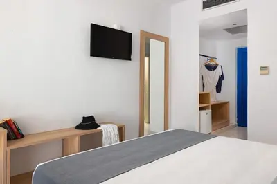 a bedroom with a bed and a tv on a wall at Eagles Nest in Pefki Rhodes