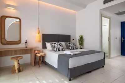 a bedroom with a large bed and a mirror at Eagles Nest in Pefki Rhodes