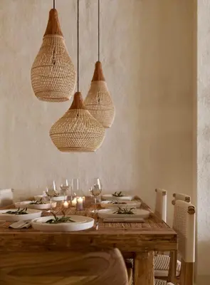 a wooden table with plates and candles and lights at Elaia Luxury House in Archangelos