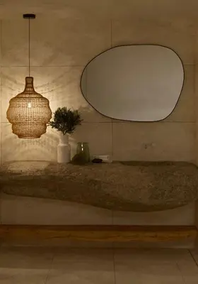 a mirror and a vase on a shelf with a plant at Elaia Luxury House in Archangelos