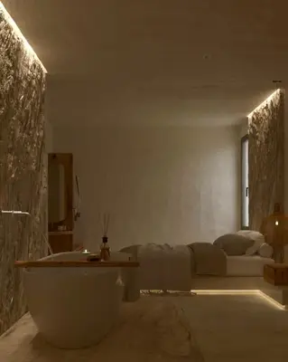 a bathroom with a bath tub and a bed at Elaia Luxury House in Archangelos